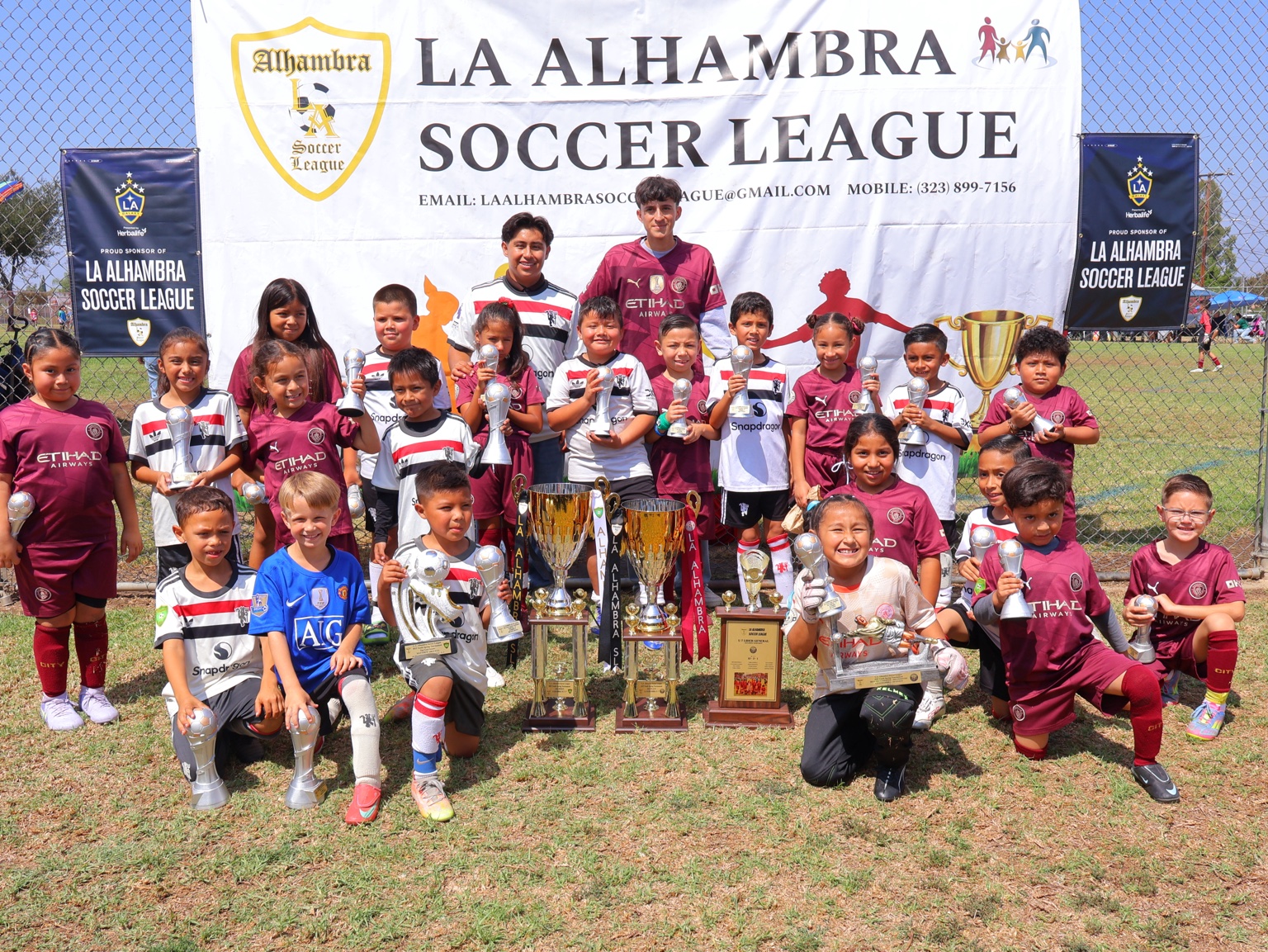 Youth soccer players with trophies
