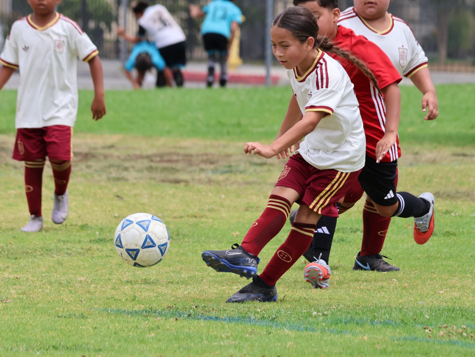 Alhambra FC player striking the ball